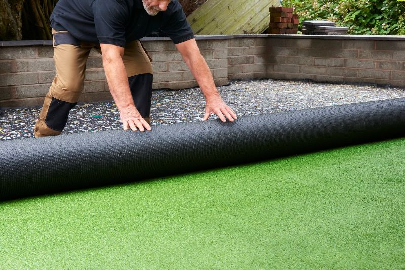 man installing artificial grass